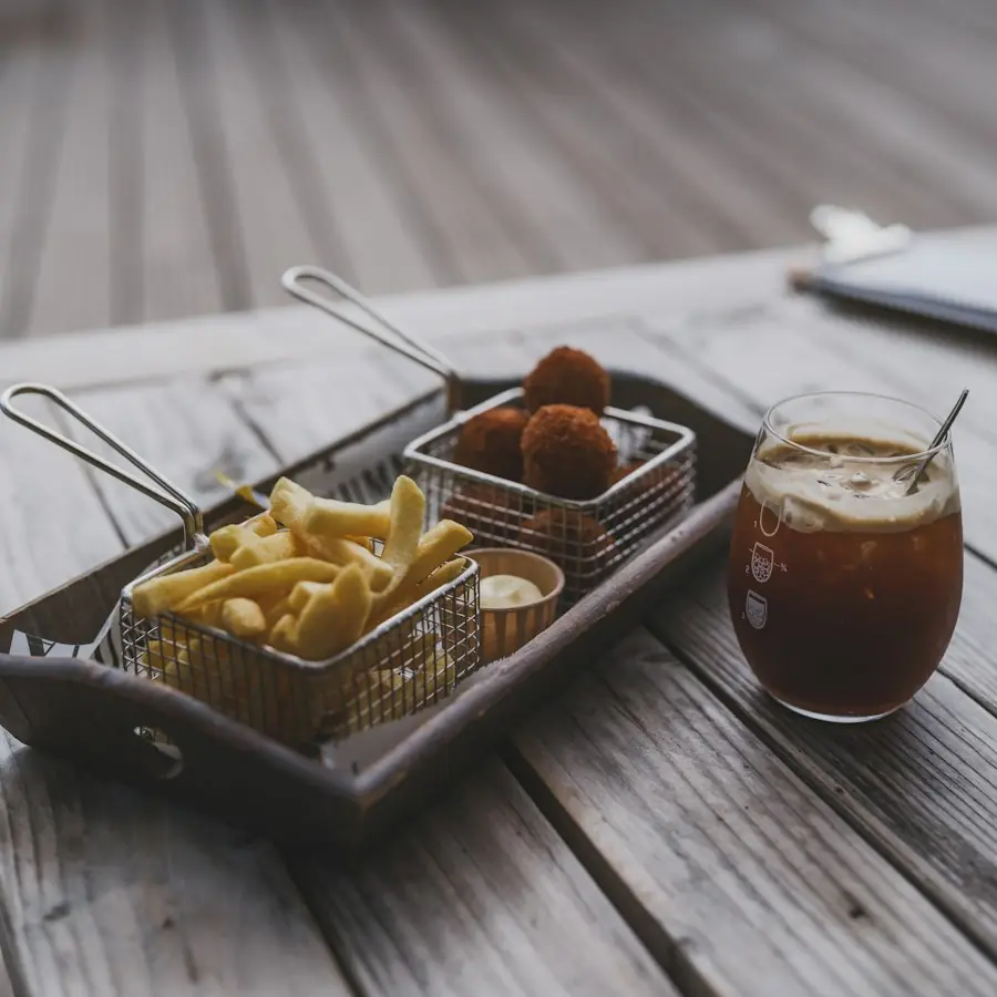 Croquettes and fries in a basket with a drink