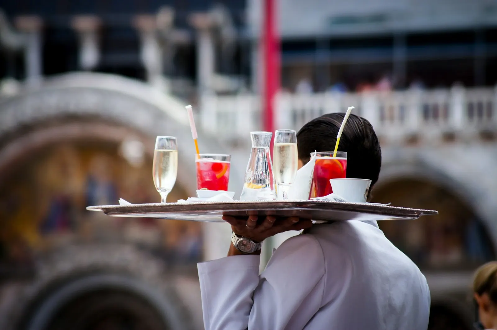 A waiter carrying a tray of drinks